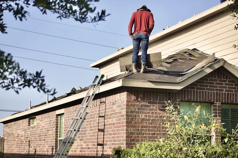 Professional roofer working on a residential roof in Tarrytown